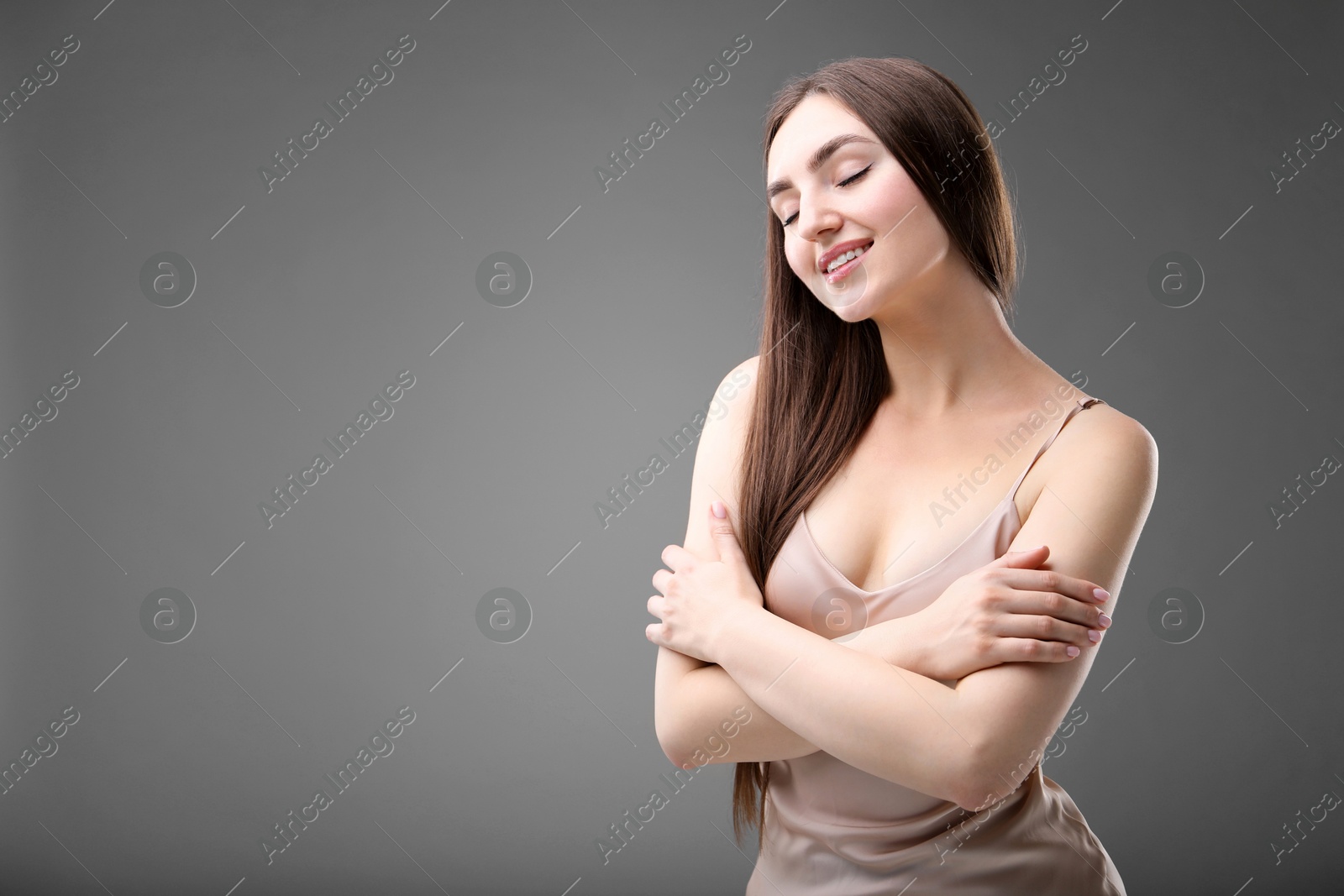 Portrait of beautiful woman on grey background. Space for text Photo of Portrait of beautiful woman on grey background. Space for text