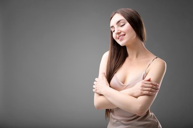 Photo of Portrait of beautiful woman on grey background. Space for text