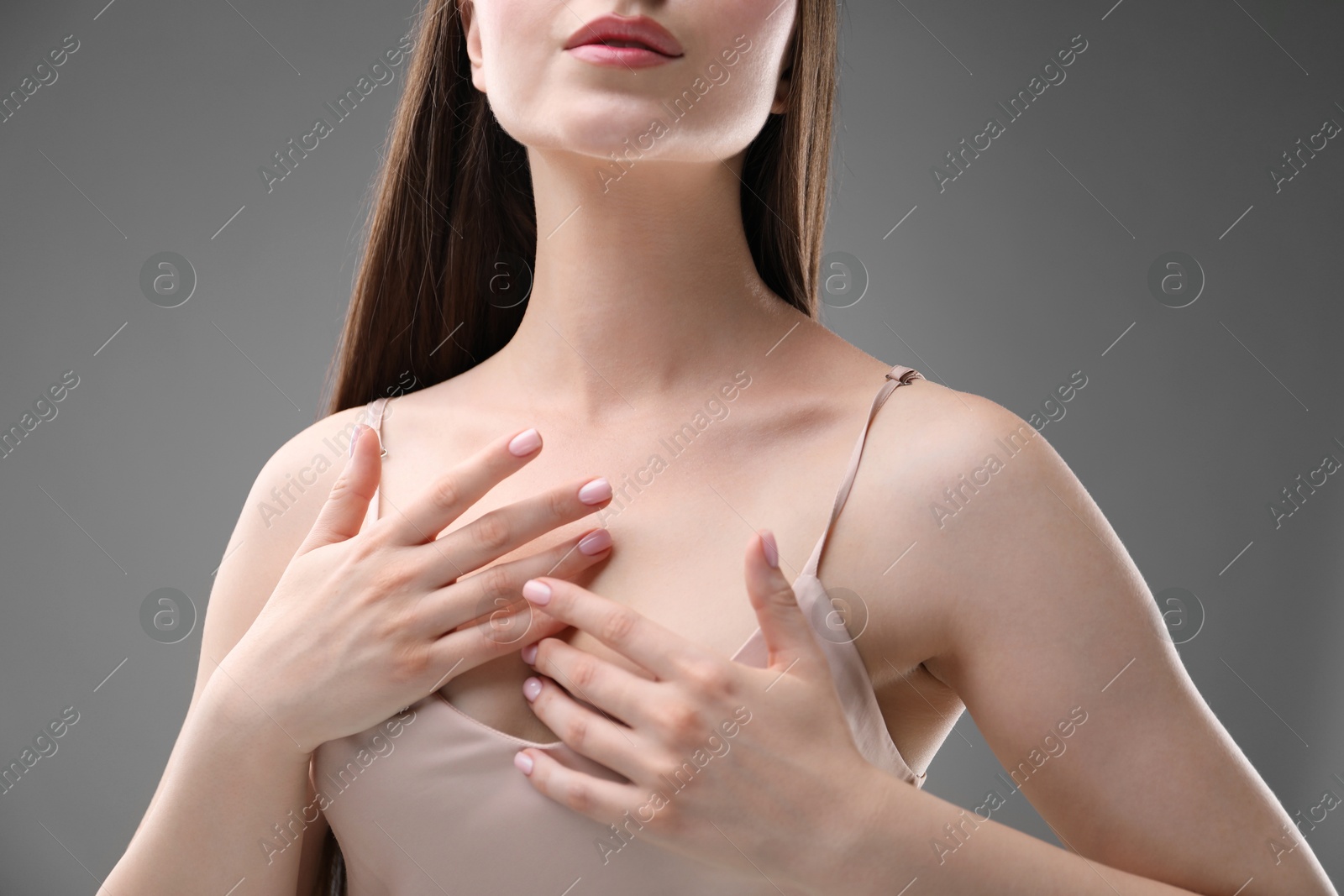 Woman with beautiful collarbones on grey background, closeup Photo of Woman with beautiful collarbones on grey background, closeup