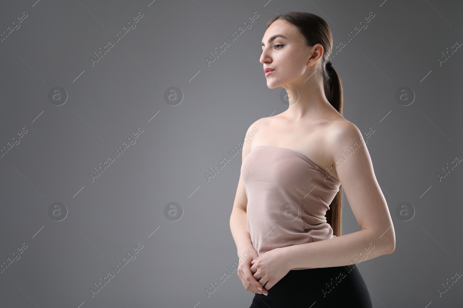 Photo of Portrait of beautiful woman on grey background. Space for text