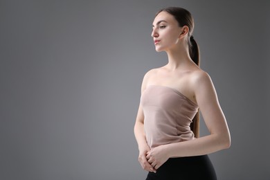 Photo of Portrait of beautiful woman on grey background. Space for text