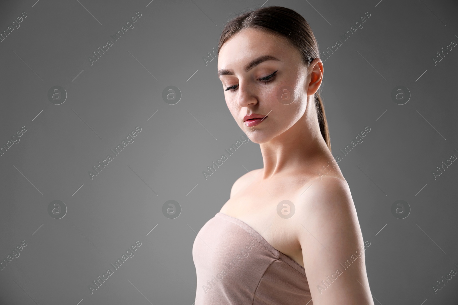 Portrait of beautiful woman on grey background. Space for text Photo of Portrait of beautiful woman on grey background. Space for text