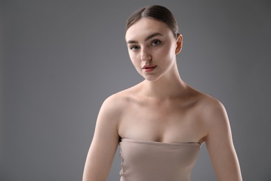Photo of Portrait of beautiful woman on grey background. Space for text