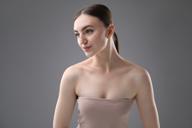 Photo of Portrait of beautiful woman on grey background