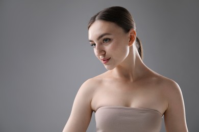 Photo of Portrait of beautiful woman on grey background. Space for text