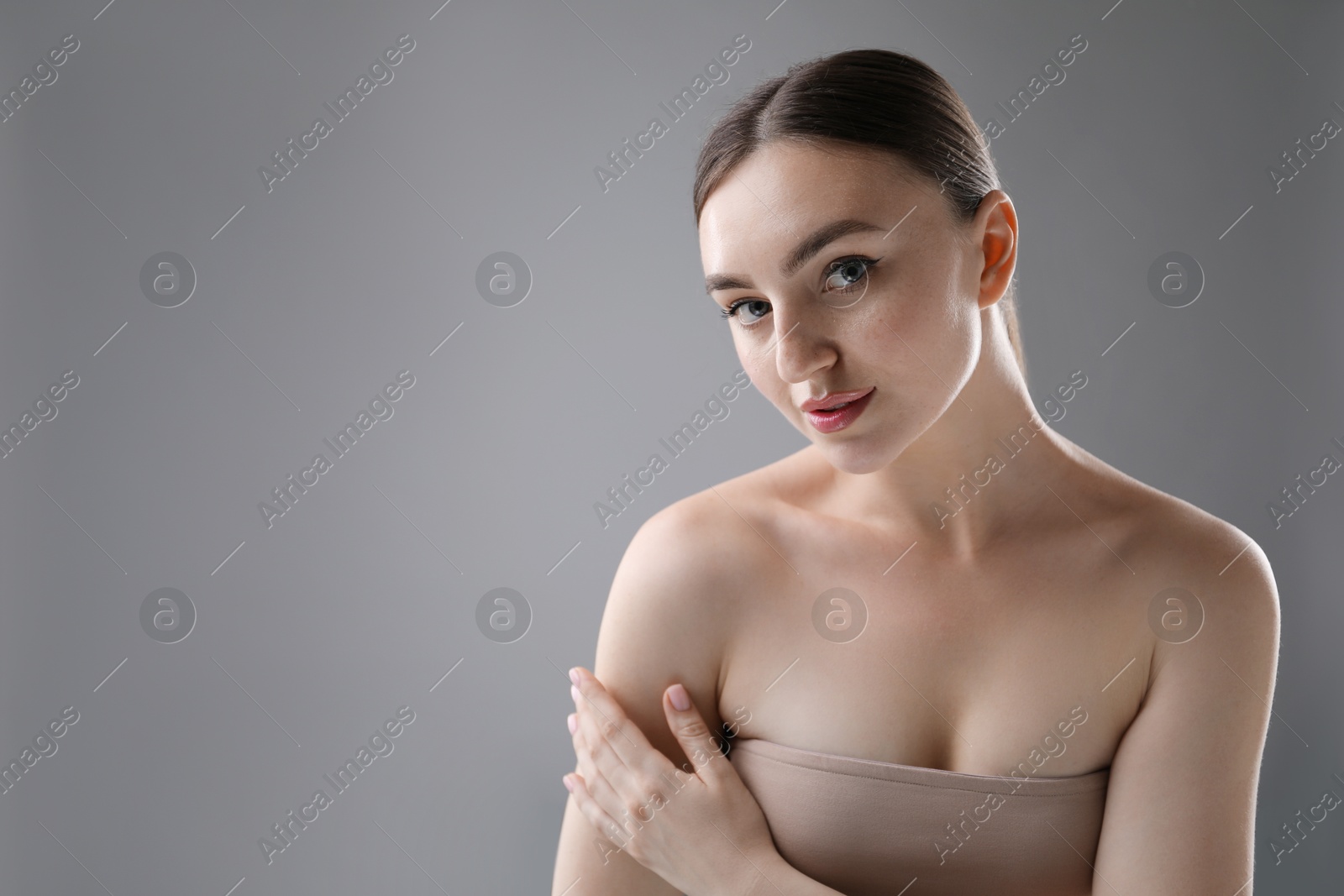 Portrait of beautiful woman on grey background. Space for text Photo of Portrait of beautiful woman on grey background. Space for text