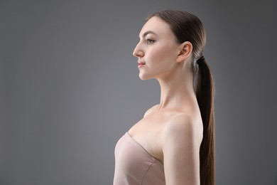 Photo of Portrait of beautiful woman on grey background. Space for text