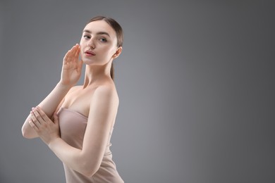 Photo of Portrait of beautiful woman on grey background. Space for text