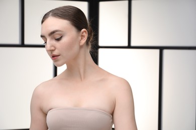 Photo of Portrait of beautiful woman on light background