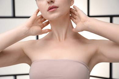 Photo of Woman with beautiful collarbones and neck on light background, closeup