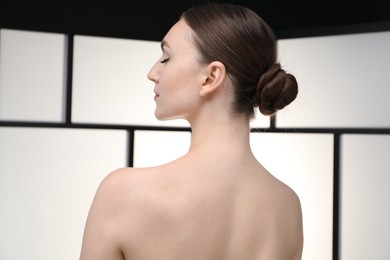 Photo of Beautiful woman on light background, back view