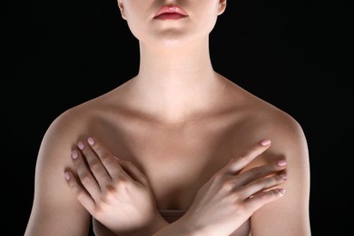 Photo of Woman with beautiful collarbones and neck on black background, closeup