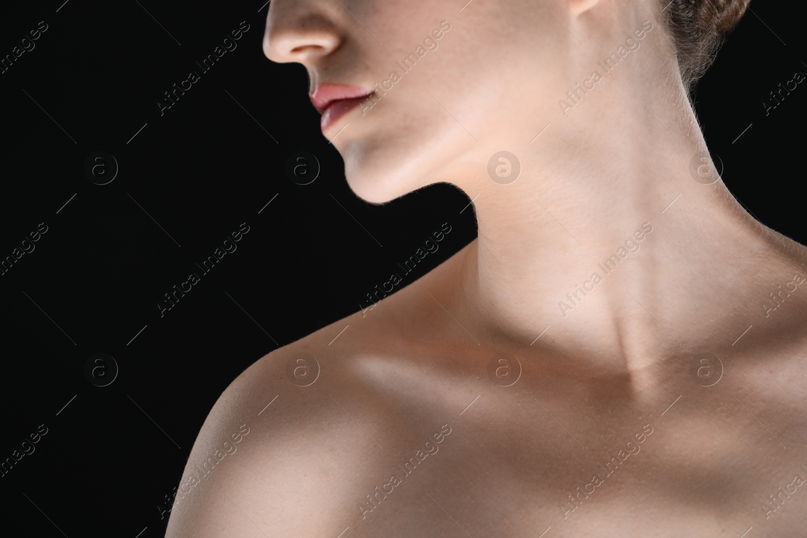 Woman with beautiful collarbones and neck on black background, closeup Photo of Woman with beautiful collarbones and neck on black background, closeup