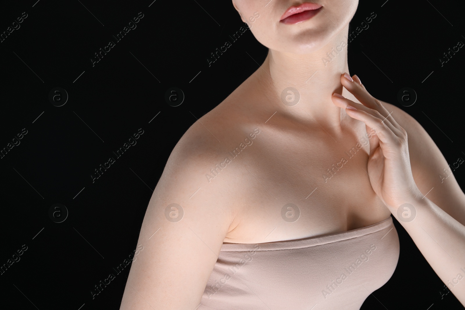 Woman with beautiful collarbones and neck on black background, closeup. Space for text Photo of Woman with beautiful collarbones and neck on black background, closeup. Space for text