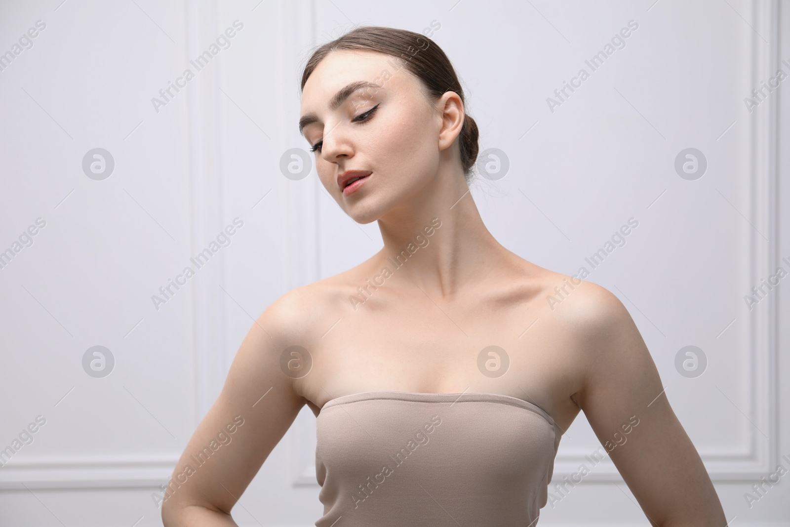Portrait of beautiful woman on light background Photo of Portrait of beautiful woman on light background