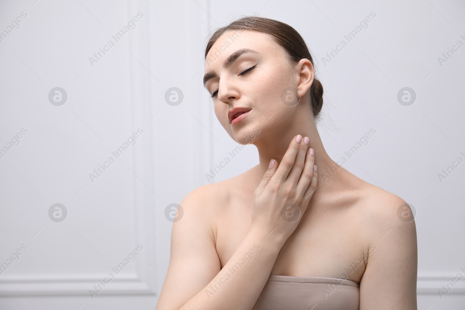Portrait of beautiful woman on light background. Space for text Photo of Portrait of beautiful woman on light background. Space for text