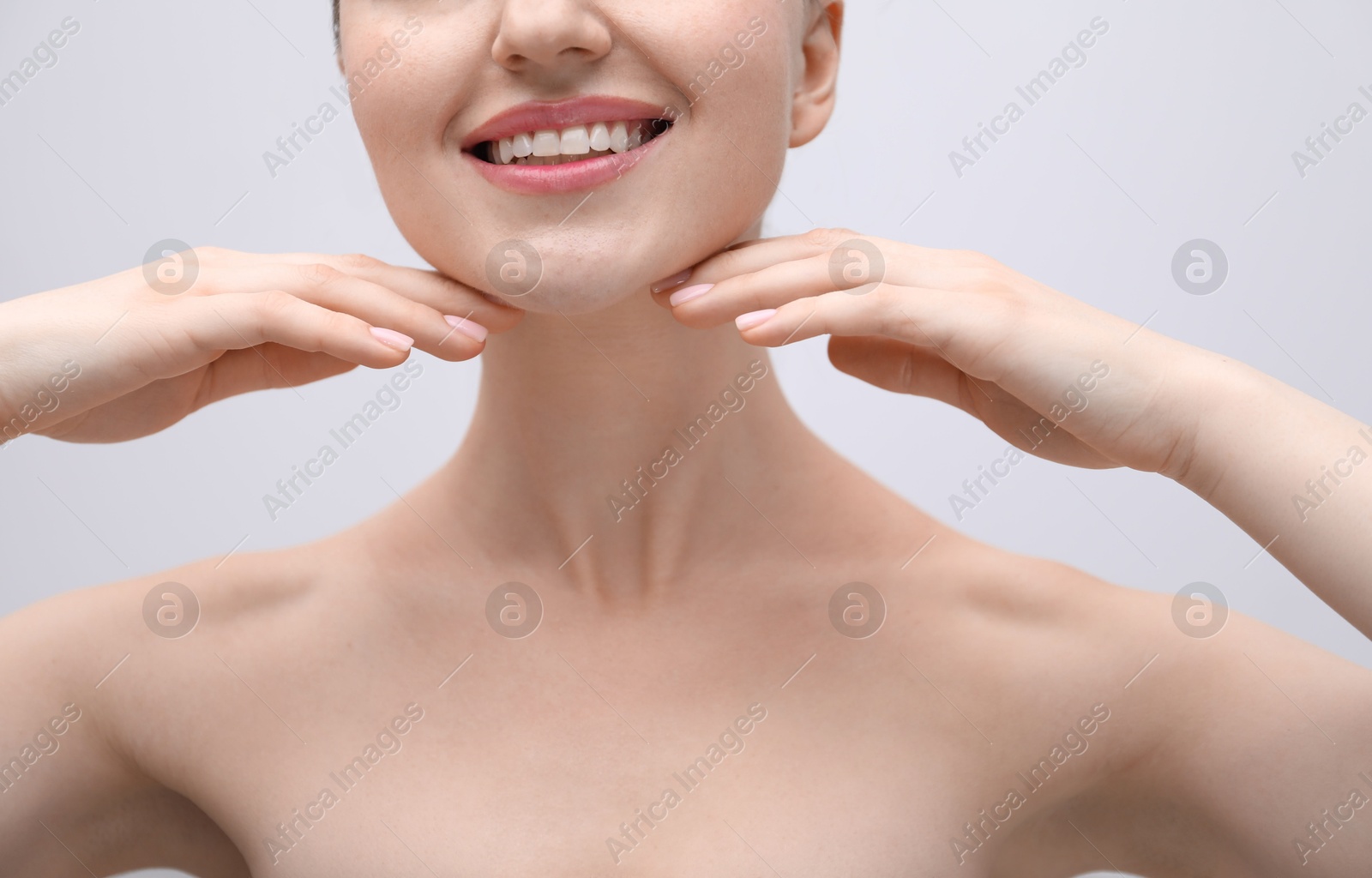 Woman with beautiful collarbones and neck on light background, closeup Photo of Woman with beautiful collarbones and neck on light background, closeup