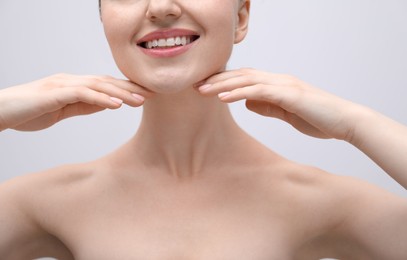 Photo of Woman with beautiful collarbones and neck on light background, closeup