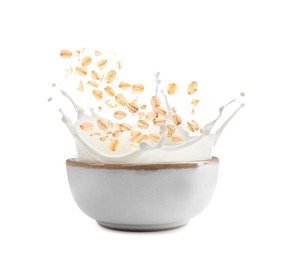Image of Oats and milk splashing out from bowl on white background