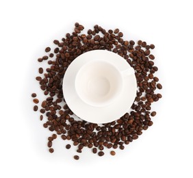 Photo of Ceramic cup with roasted coffee beans isolated on white, top view