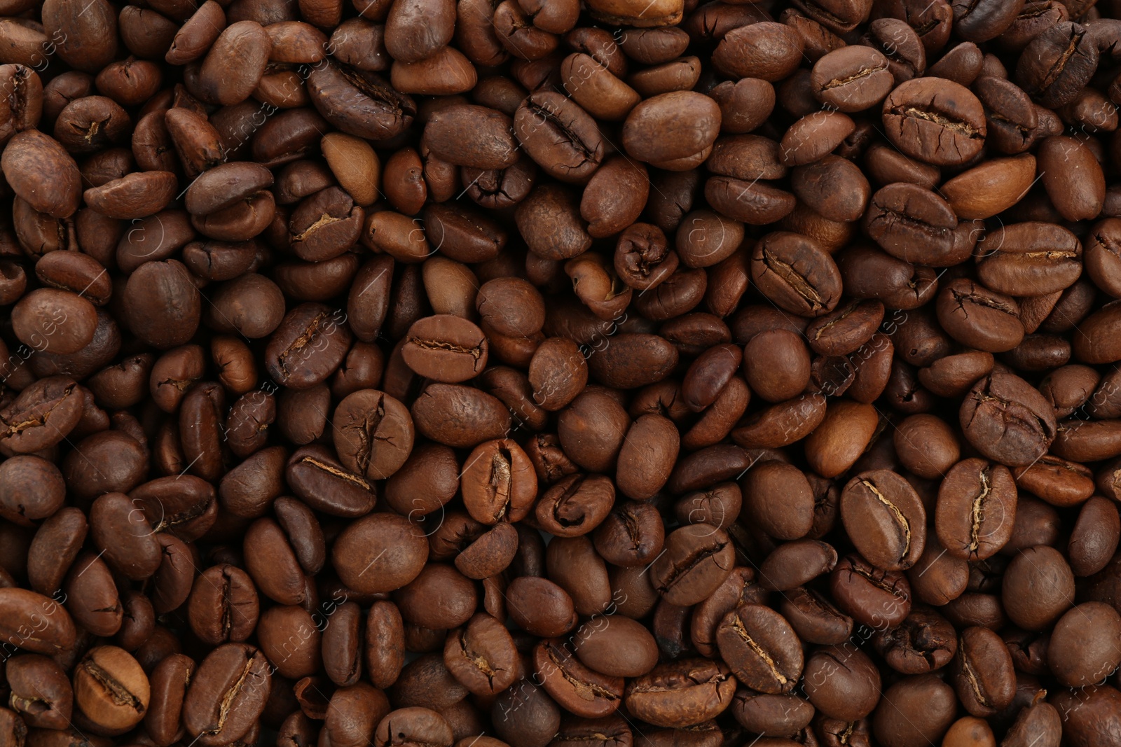 Roasted coffee beans as background, closeup view Photo of Roasted coffee beans as background, closeup view