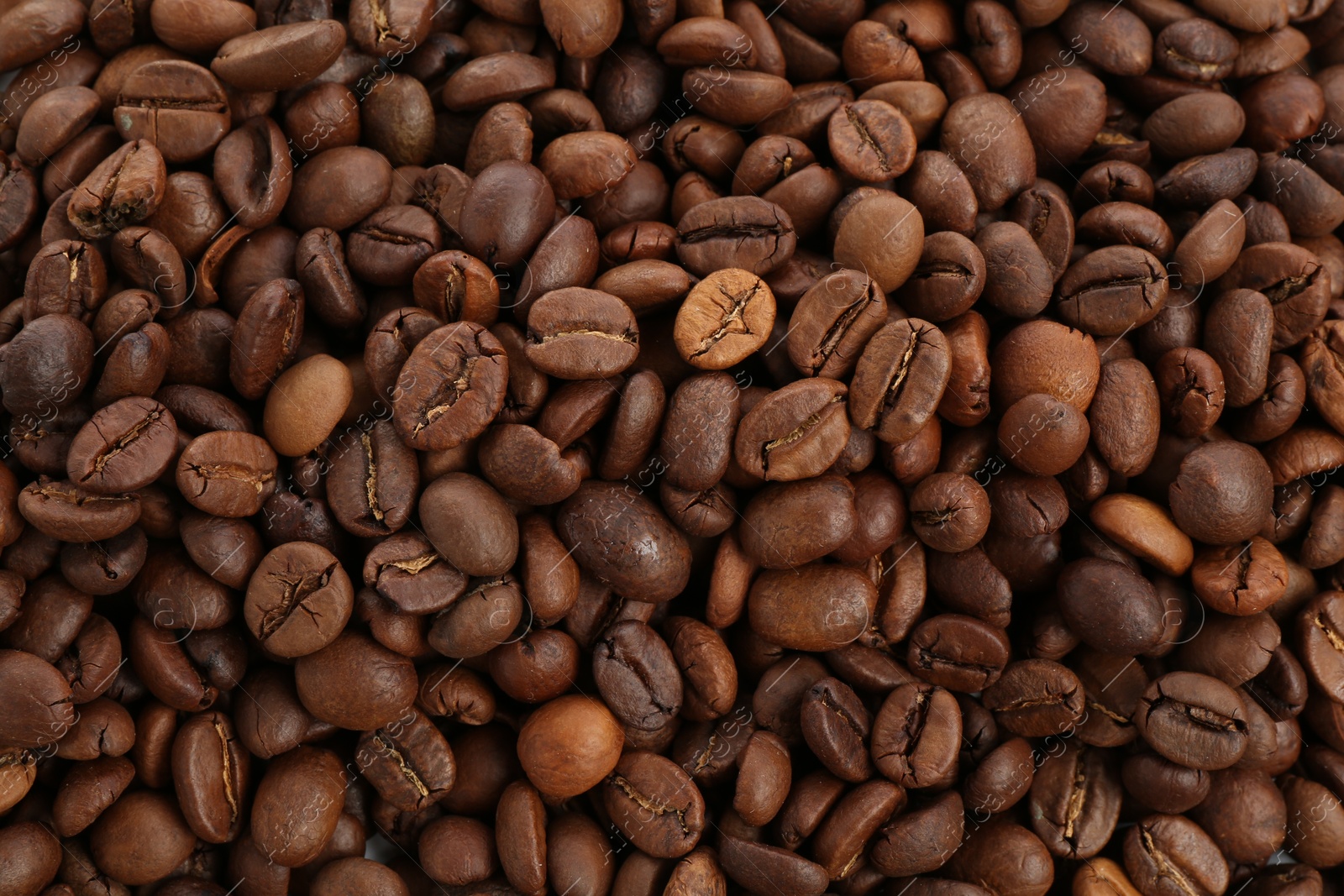 Roasted coffee beans as background, closeup view Photo of Roasted coffee beans as background, closeup view