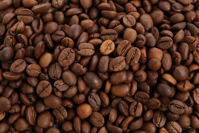 Photo of Roasted coffee beans as background, closeup view