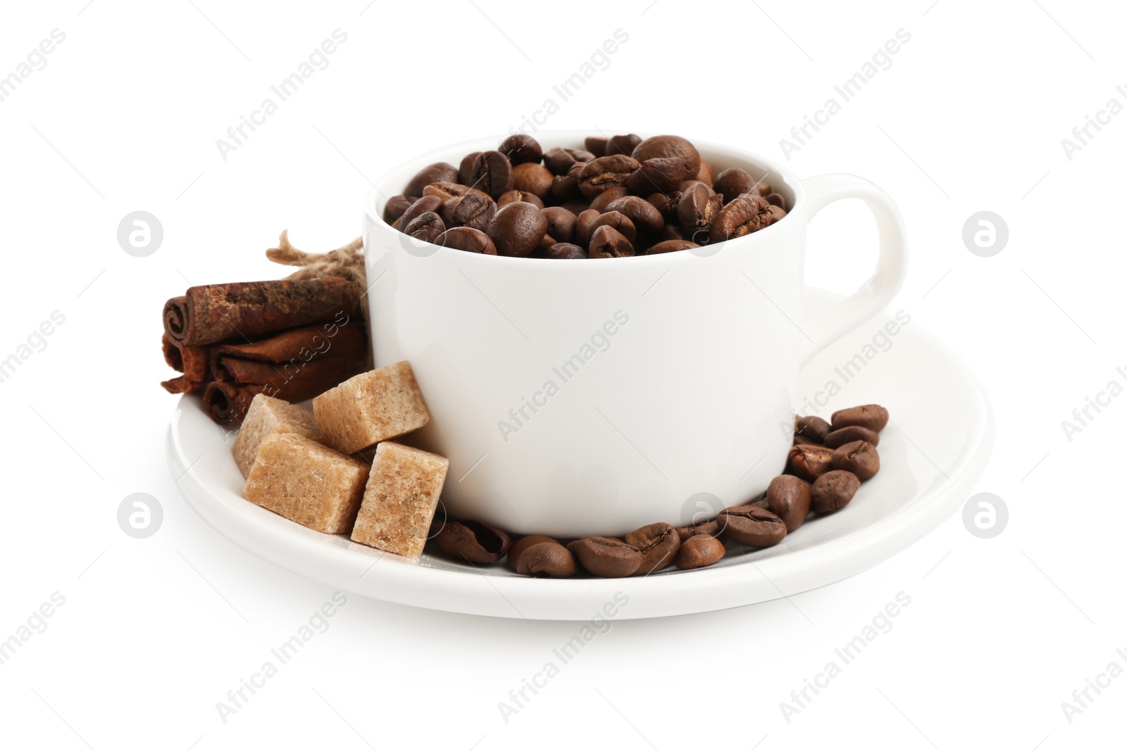 Ceramic cup with roasted coffee beans, sugar and cinnamon isolated on white Photo of Ceramic cup with roasted coffee beans, sugar and cinnamon isolated on white