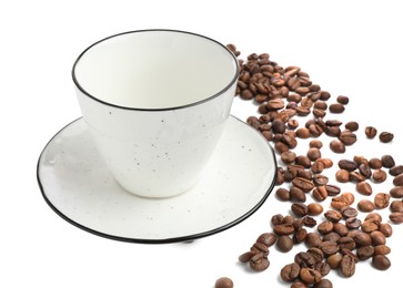 Photo of Ceramic cup with roasted coffee beans isolated on white