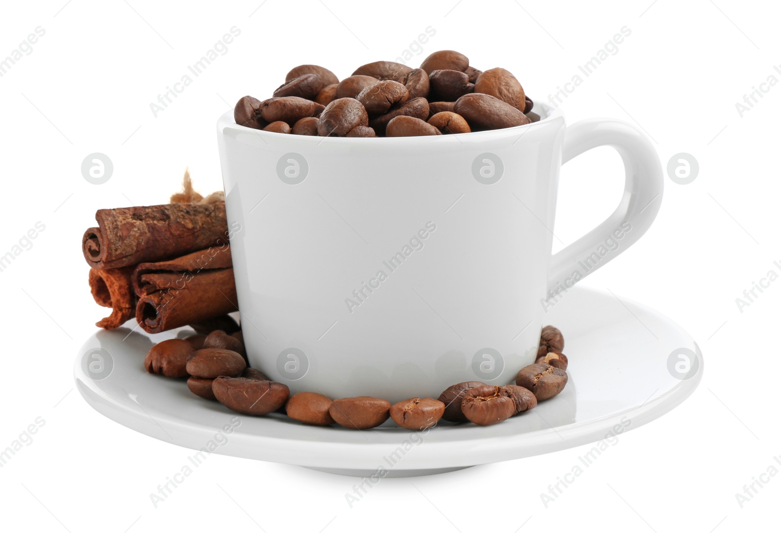 Ceramic cup with roasted coffee beans and cinnamon isolated on white Photo of Ceramic cup with roasted coffee beans and cinnamon isolated on white