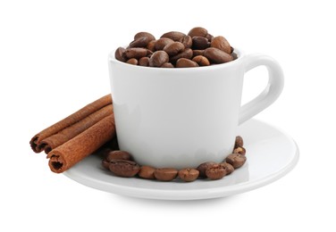 Photo of Ceramic cup with roasted coffee beans and cinnamon isolated on white