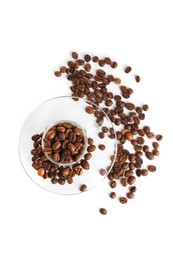Photo of Glass cup with roasted coffee beans isolated on white, top view