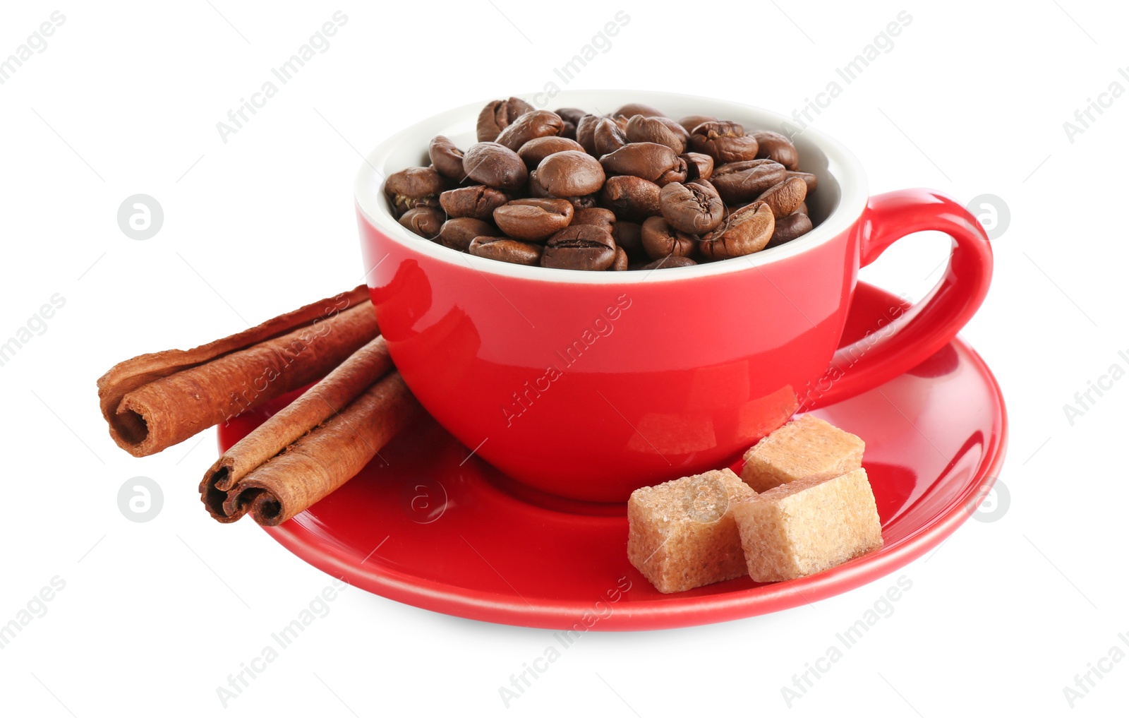 Ceramic cup with roasted coffee beans, sugar cubes and cinnamon isolated on white Photo of Ceramic cup with roasted coffee beans, sugar cubes and cinnamon isolated on white