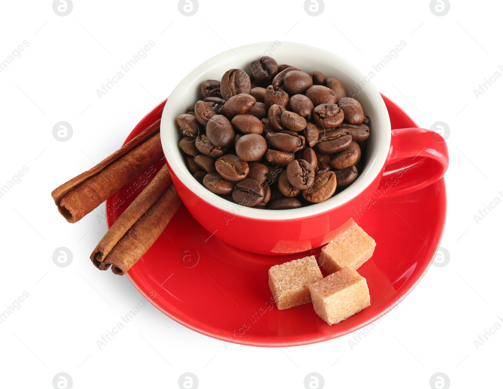 Ceramic cup with roasted coffee beans, sugar cubes and cinnamon isolated on white Photo of Ceramic cup with roasted coffee beans, sugar cubes and cinnamon isolated on white