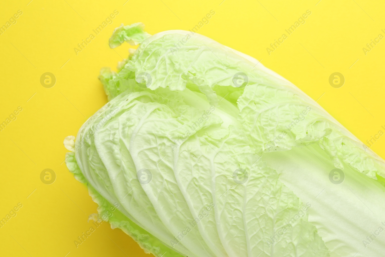 One fresh Chinese cabbage on yellow background, above view Photo of One fresh Chinese cabbage on yellow background, above view
