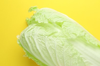 Photo of One fresh Chinese cabbage on yellow background, above view