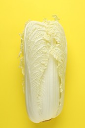 Photo of One fresh Chinese cabbage on yellow background, top view