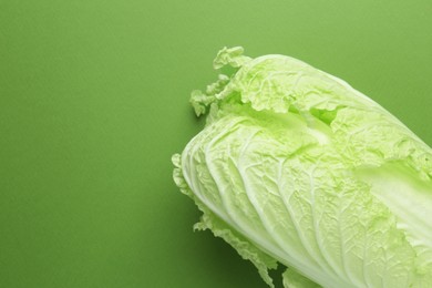 Photo of One fresh Chinese cabbage on green background, above view. Space for text