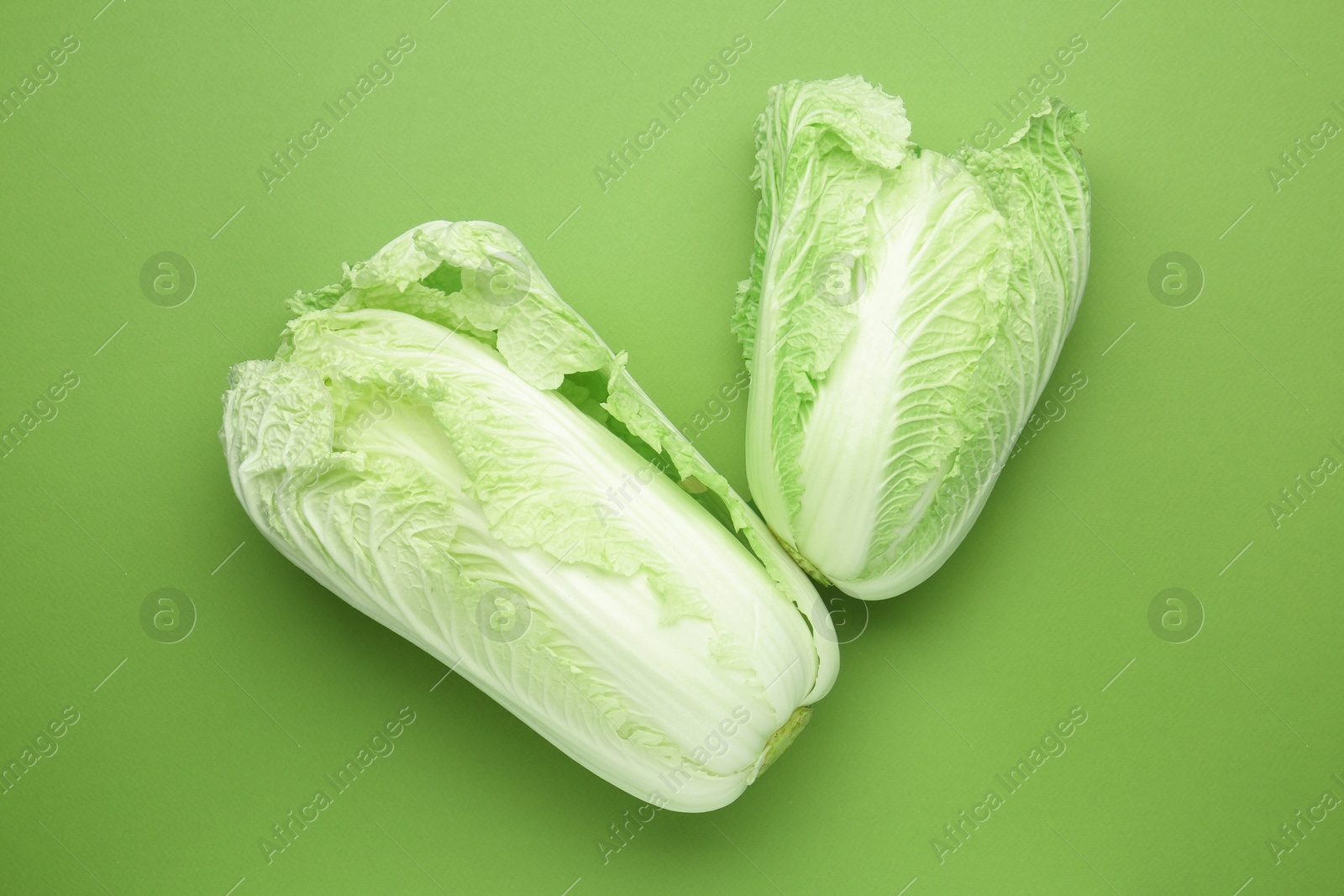 Fresh Chinese cabbages on green background, top view Photo of Fresh Chinese cabbages on green background, top view