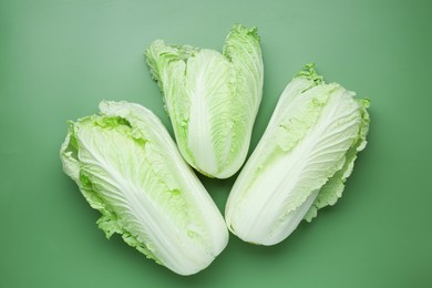 Photo of Fresh Chinese cabbages on green background, flat lay