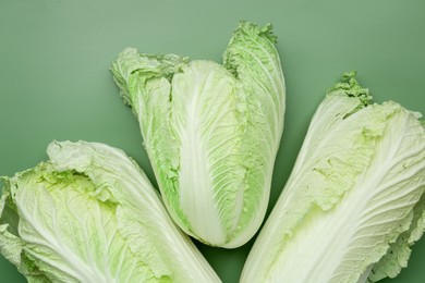 Photo of Fresh Chinese cabbages on green background, flat lay