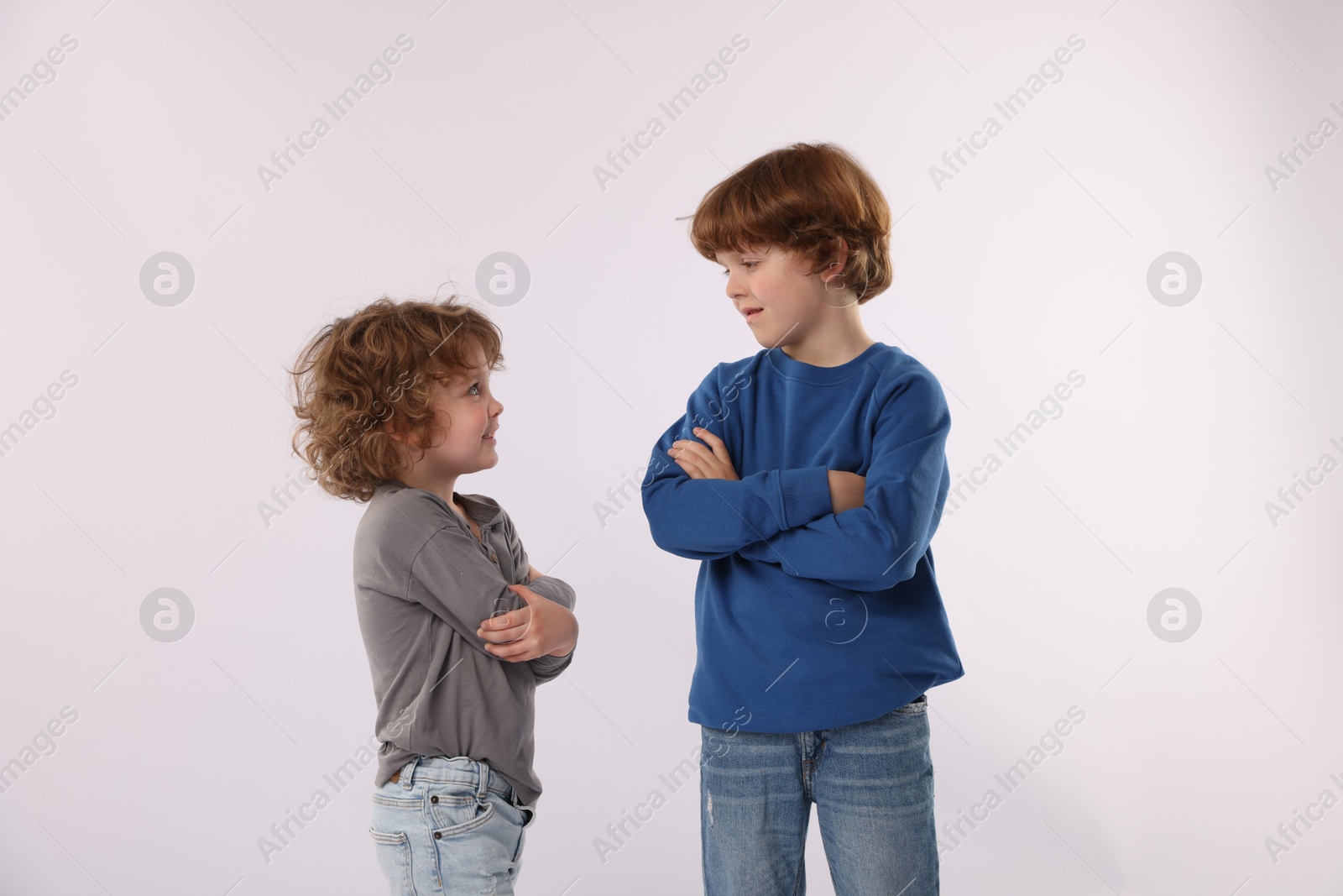Cute little brothers posing on white background Photo of Cute little brothers posing on white background