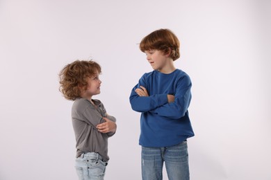 Photo of Cute little brothers posing on white background