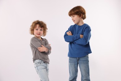 Photo of Cute little brothers posing on white background