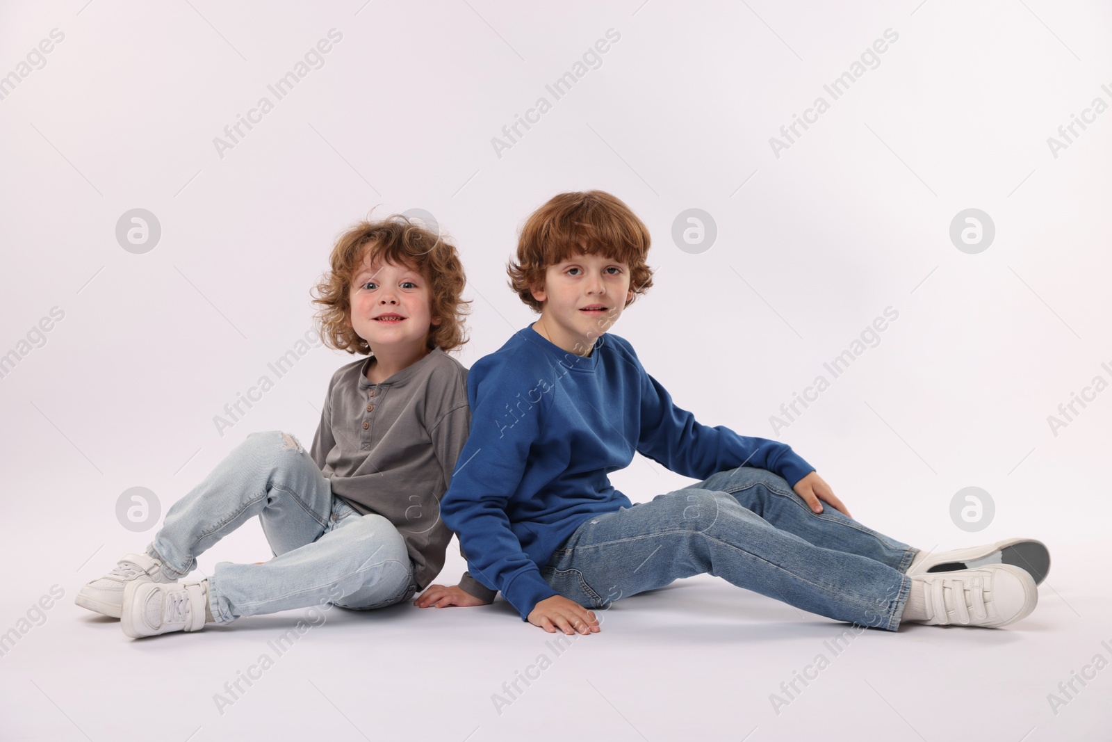 Cute little brothers posing on white background Photo of Cute little brothers posing on white background
