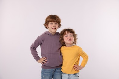 Photo of Cute little brothers hugging on white background