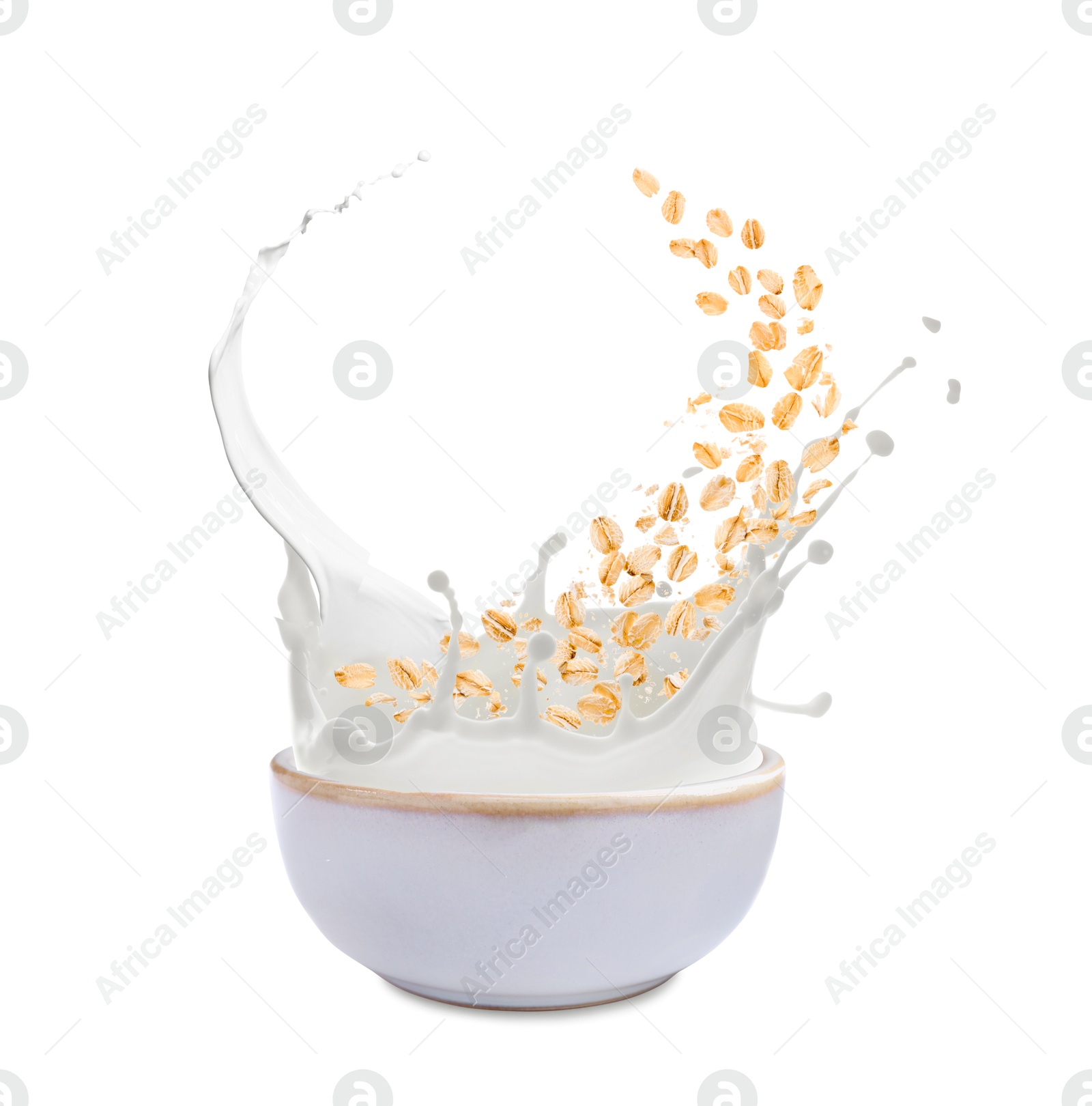 Oats and milk splashing out from bowl on white background Image of Oats and milk splashing out from bowl on white background