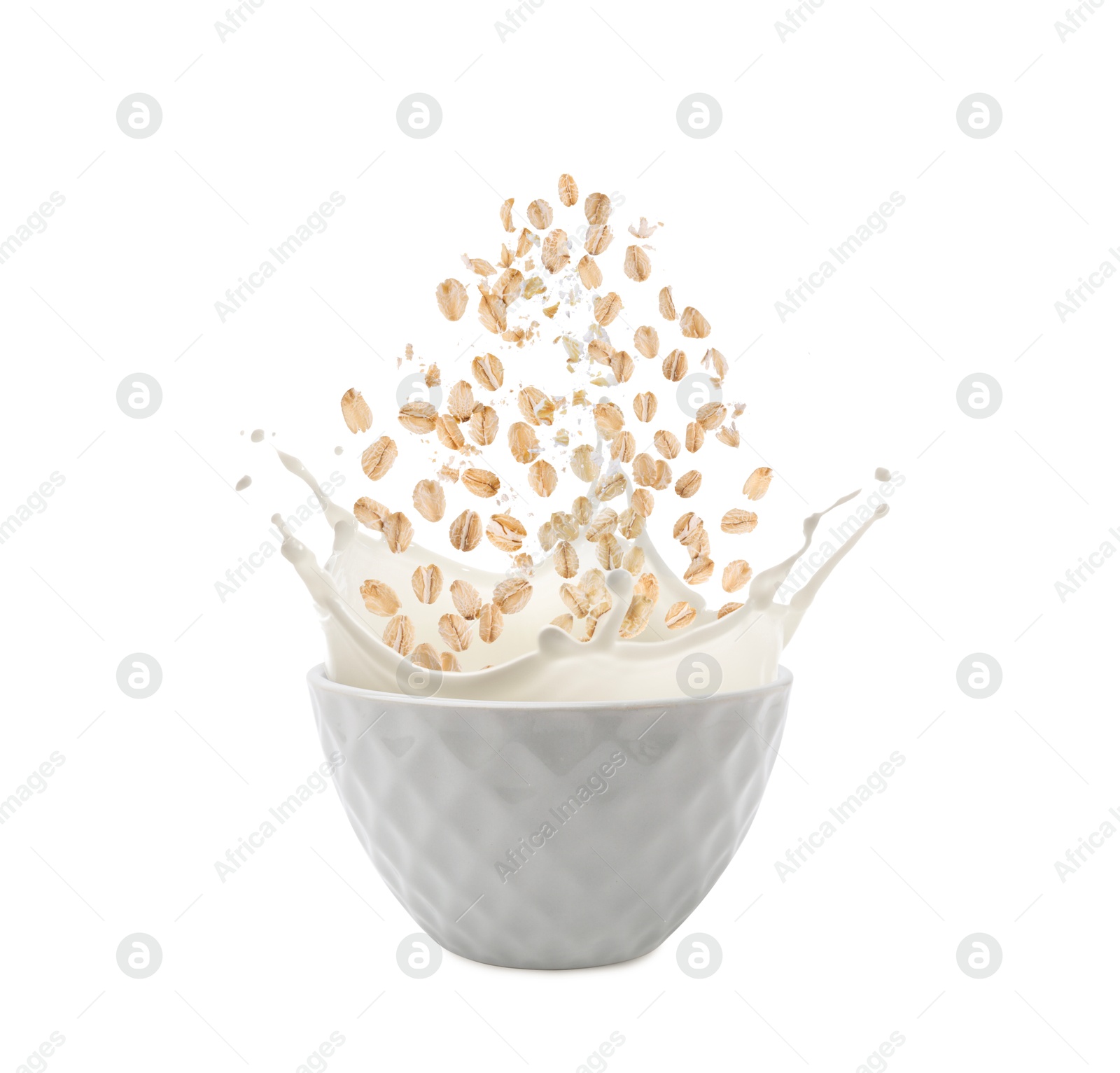 Oats and milk splashing out from bowl on white background Image of Oats and milk splashing out from bowl on white background