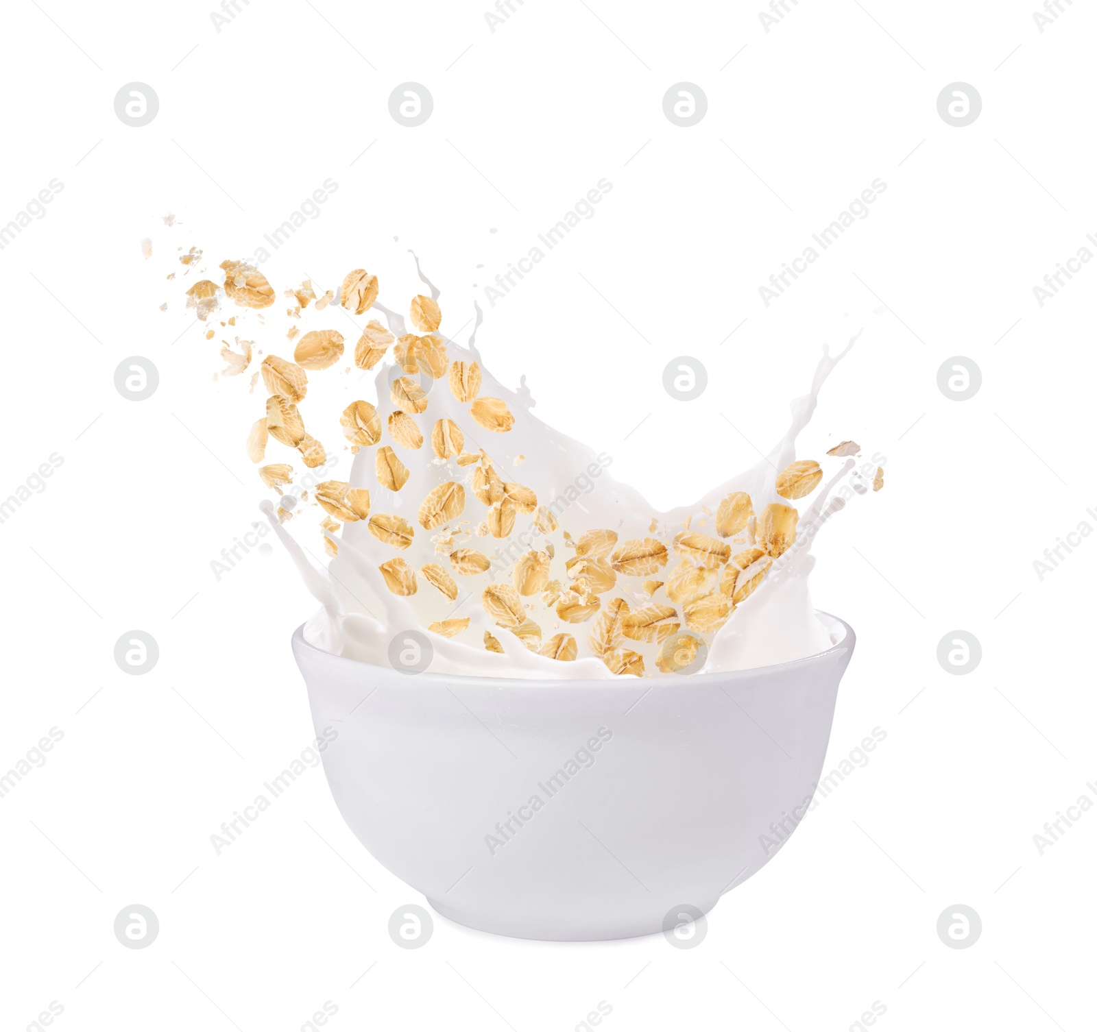 Oats and milk splashing out from bowl on white background Image of Oats and milk splashing out from bowl on white background
