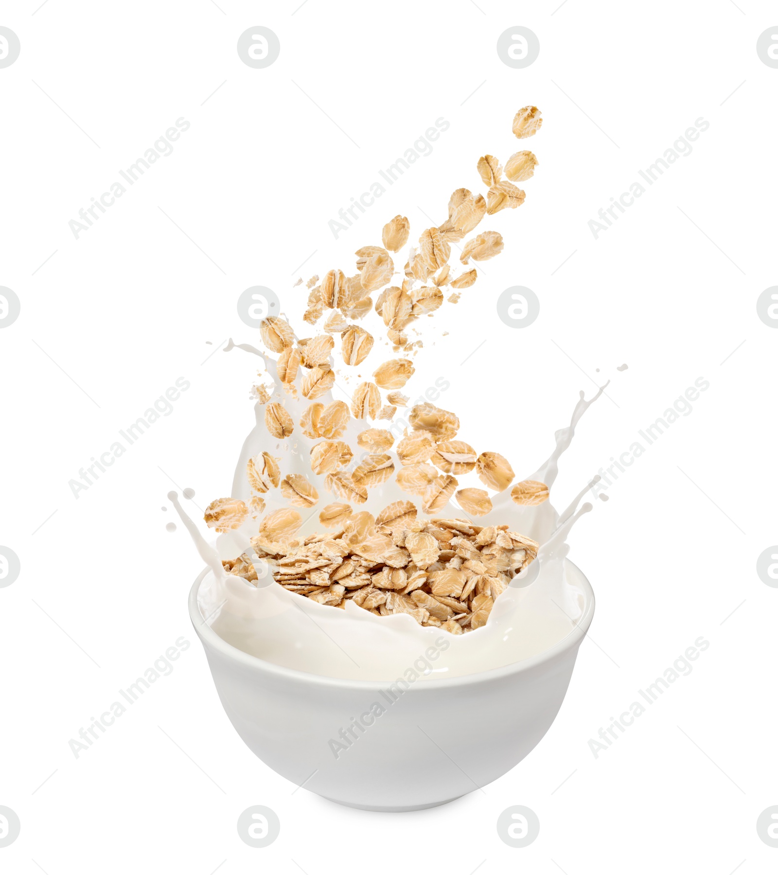 Oats and milk splashing out from bowl on white background Image of Oats and milk splashing out from bowl on white background